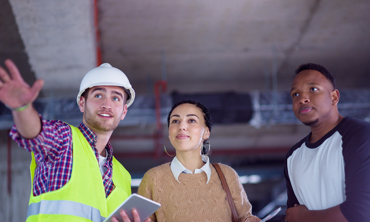 Couple and builder discussing building plan